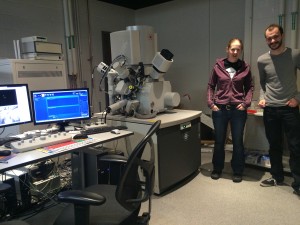 Heather showing off the new Scanning Electron Microscope, with Eric